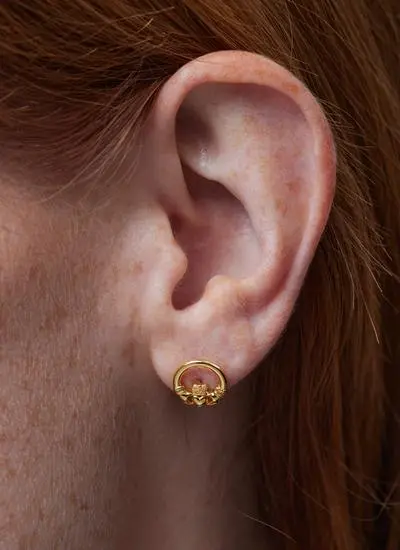 Close up of red haired model wearing 14ct Gold Vermeil Claddagh Stud Earrings